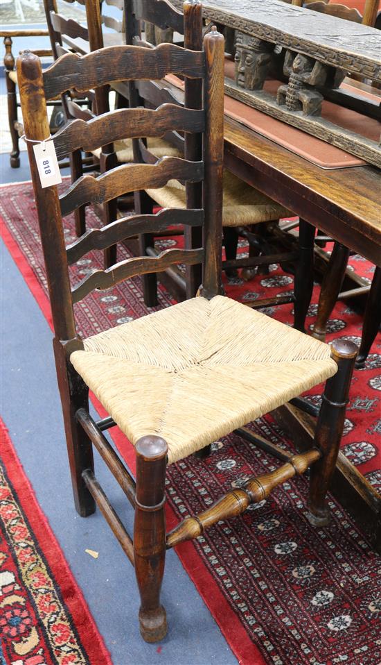 A set of eight oak rushseat ladderback chairs